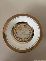 Front view of porcelain plate showing gold rim and "Happy 40th Anniversary" Chokin center