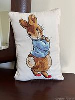 Front view of pillow showing Peter Rabbit embroidery