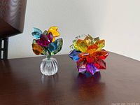 Both crystal flower ornaments on wood surface