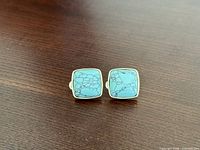 front view showing square turquoise cabochons