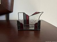 Front view of stained glass business card holder showing clear, burgundy and black panels