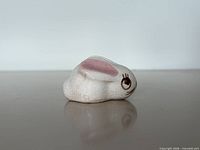 right side view of crackle glaze rabbit showing profile, glaze texture and pink ear