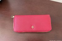 Front view of red Tory Burch wallet closed