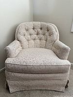 Front view of damask upholstered armchair