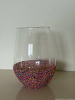 Front view of clear glass vase with coloured beads