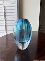 Front view of ovoid aqua and clear striped art glass vase