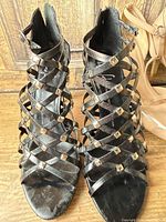 Front view of black strappy sandals showing studded straps and open toe