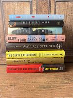 Stack of eight hardcover books showing spines and titles