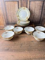 Set of six cups and stack of saucers