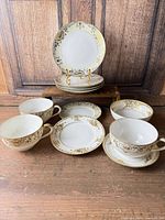 Group view showing 4 cups, 4 saucers, 3 plates including one plate on stand