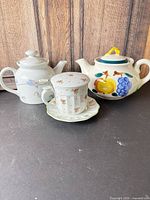 Overall shot showing Stangl teapot, Toscany infuser mug with lid, and matching saucer