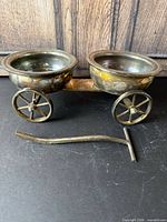 Overall view of wagon-form caddy showing two bowls, wheels and detached handle