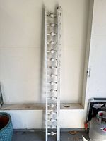 Full length view of white wooden trim piece standing upright