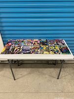 Overall view of all twelve comics laid out on table