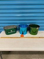 Group shot of Moosehead beer tub, two buckets, service bell with ruler for scale