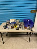 Overall view of all hand tools and hardware on table