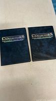 Front covers of two navy blue Collectors Card Albums