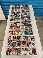 Overview of multiple binder pages filled with hockey cards laid on table