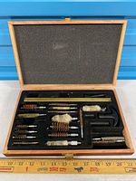 open wooden case showing full kit components in foam tray