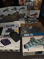 Overall group of five boxed kits showing tank, MiG-15 and multiple cannon boxes