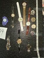 Group shot of all ten wristwatches on black background