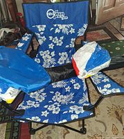 Blue floral folding chair with cup holder, carry bag, beach balls packaging visible