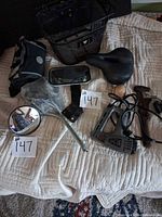 Overview of basket, saddle, mirrors, bag, staple gun, wrench, lock, reflectors