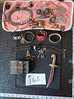 Entire lot laid out including jewellery pieces and dagger