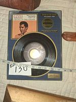 Close-up of Elvis Presley limited-edition wall plaque with 45rpm record and sleeve