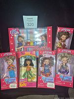 Group shot of seven boxed dolls including large playset and five smaller window boxes