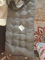 Grey quilted cushion pad with attached pillow