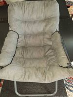 Front view showing padded seat, back and armrests