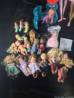 Overview of entire lot showing variety of dolls and accessories