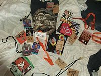 Full lot overview with T-shirt, bandana, passes, lanyards, pins and keychain visible