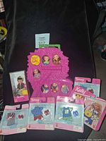 Lot overview showing carry case, fashion packs, boxed Pilot Tommy