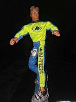 Full-body view of Max Steel figure standing on snowboard