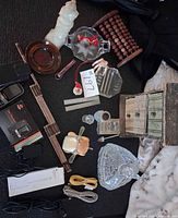 Overhead view showing all items including decanter, ashtray, abacus, rulers, chest, phone, cables, figurine, toy
