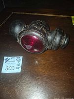 Side view showing red glass lens and metal housing