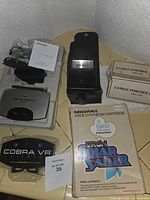 Group shot of all items including Tron Solar Sailer box, Canon flash, Home Theater Master accessory, Cobra VR viewer, and two candle boats