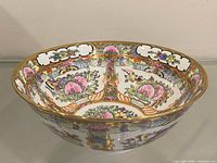 Full view of porcelain bowl showing Rose Medallion decoration and gold rim
