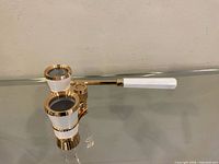 Opera glasses angled view showing barrels, bridge and retracted handle