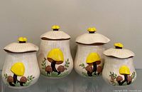 Front view of all four mushroom canisters