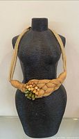 Front view of braided rope necklace on bust form