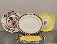 Five plates displayed front view showing designs and shapes