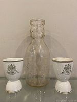 Front view of glass bottle and both egg cups