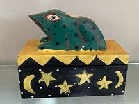 front view of frog trinket box showing star and moon design