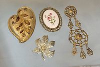 overview of all four gold-tone brooches