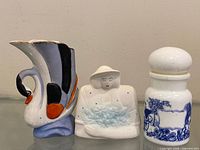 Three ceramic pieces: swan vase, figurine, lidded jar