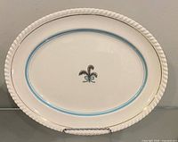 Full view of oval platter front showing border, bands, crest