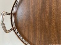 Close-up of rim, handle and wood-grain base